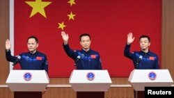 Astronauts Fei Junlong, Deng Qingming and Zhang Lu attend a news conference before the Shenzhou-15 spaceflight mission to build China's space station, at Jiuquan Satellite Launch Center, near Jiuquan, Gansu province, China Nov. 28, 2022.