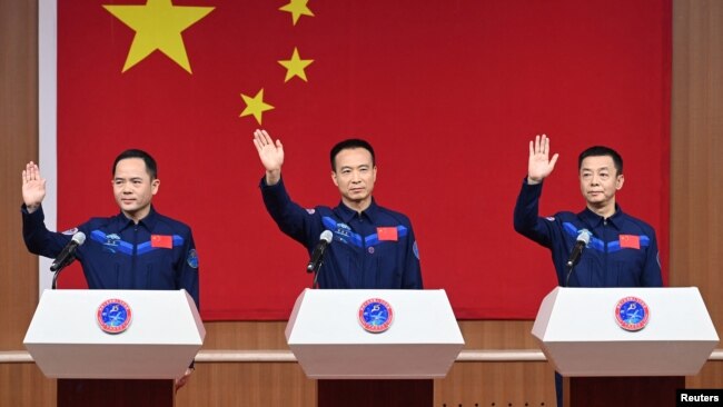 Astronauts Fei Junlong, Deng Qingming and Zhang Lu attend a news conference before the Shenzhou-15 spaceflight mission to build China's space station, at Jiuquan Satellite Launch Center, near Jiuquan, Gansu province, China Nov. 28, 2022.