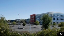 A nearly empty parking lot is shown at Facebook headquarters in Menlo Park, Calif., Tuesday, April 14, 2020. (AP Photo/Jeff Chiu)