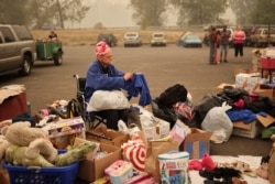 A woman is seen at a makeshift distribution center for people displaced by the wildfires, at a parking lot in Oregon City, Ore., Sept. 11, 2020.