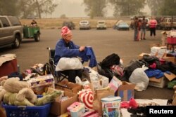 A woman is seen at a makeshift distribution center for people displaced by the wildfires, at a parking lot in Oregon City, Ore., Sept. 11, 2020.