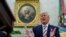 U.S. President Donald Trump answers questions from reporters sitting in front of a portrait of former U.S. President George Washington in the Oval Office of the White House in Washington, Aug. 20, 2019.