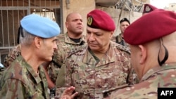 Lebanese army commander, General Joseph Aoun (C), speaks with Major General Aroldo Lazaro, Head of Mission and Force Commander of UNIFIL during a visit to the southern Lebanese village of Khiam, Dec. 23, 2024,