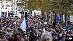 FILE —Thousands march through central Paris during a “silent march” calling for peace in the Middle East, in Paris on November 19, 2023.