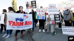 Protesters rally outside the Iowa Agriculture Summit in Des Moines, Iowa, where nine Republican presidential hopefuls discussed a variety of issues, March 7, 2015.