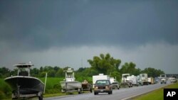 Boats, trailers and RVs line Louisiana Highway 46 after owners moved them to be inside the levee protection zone before Hurricane Ida makes landfall in St. Bernard Parish, La., Aug. 28, 2021. 