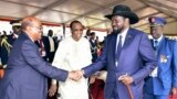 FILE - President Omar al-Bashir of Sudan, left, and President Salva Kiir of South Sudan shake hands during the inauguration ceremony of Uganda's long-time president Yoweri Museveni in the capital Kampala, May 12, 2016.