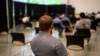 FILE - Georgia Tech employee Adam Jackson waits after receiving a Pfizer COVID-19 vaccination at the Vaccination Site on the campus of Georgia Tech, April 8, 2021 in Atlanta. 