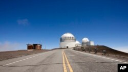 FILE - In this Aug. 31, 2015, file photo, telescopes are viewed on Mauna Kea, the proposed construction site for a new $1.4 billion telescope. 