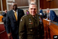 Secretary of Defense Lloyd Austin, left, and Joint Chiefs Chairman Gen. Mark Milley, arrive for a Senate Armed Services budget hearing on Capitol Hill in Washington, June 10, 2021.