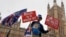 A demonstrator protests in front of parliament in London, Oct. 17, 2018. 