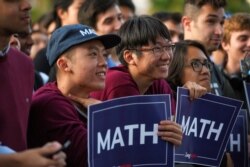 FILE - Supporters listen as Democratic U.S. presidential candidate Andrew Yang speaks during a rally in Cambridge, Mass., Sept. 16, 2019.