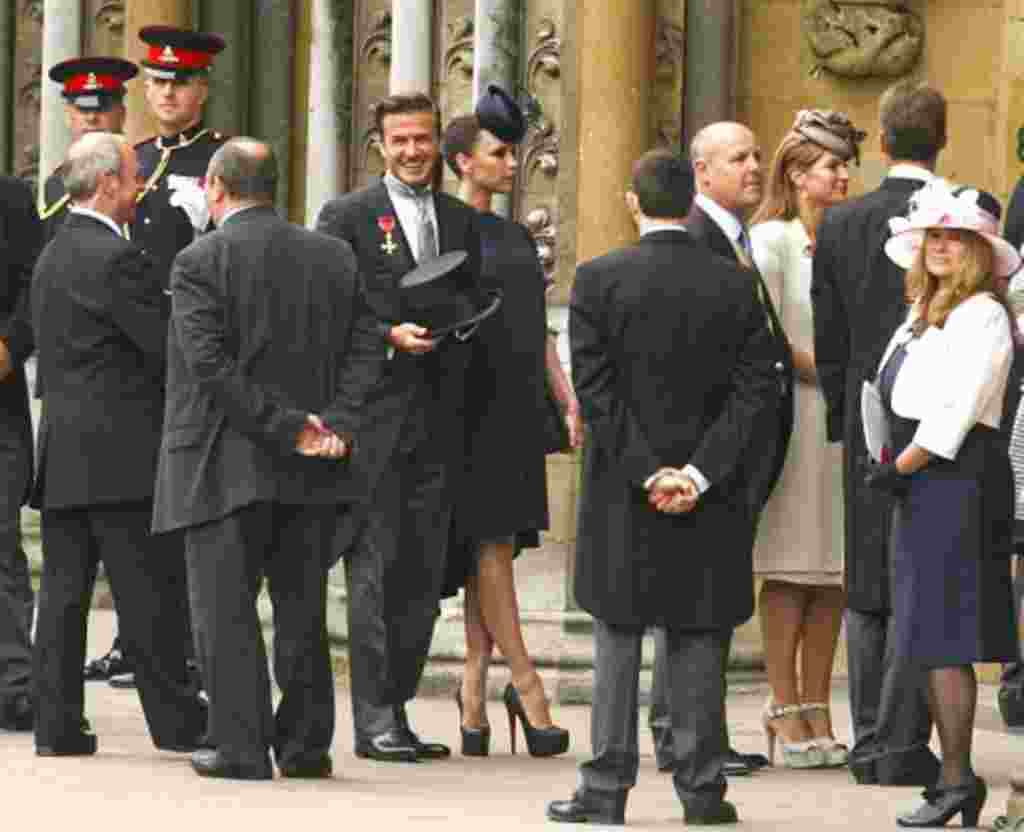 Soccer star David Beckham (C) and his wife Victoria arrive at Westminster Abbey before the wedding of Britain's Prince William and Kate Middleton, in central London April 29, 2011.