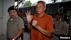 Thanat Thanawatcharanon, also known by his stage name Tom Dundee, a Thai actor, singer and political activist, who was accused of insulting the king in public speech, gestures as he arrives at the criminal court in Bangkok, Thailand, June 1, 2016.