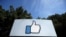 FILE - The thumbs-up Like logo is shown on a sign at Facebook headquarters in Menlo Park, Calif., April 14, 2020. 