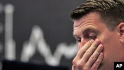 Stock trader Michael Pansegrau reacts at the German stock exchange in Frankfurt, central Germany, Aug. 5, 2011