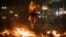 A demonstrator jumps over trash set afire during protests against poor public services, police violence and government corruption, in Sao Paulo, Brazil, June 18, 2013. 