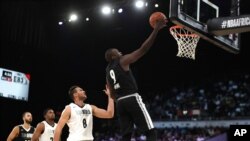 FILE - Team Africa's Luol Deng, right, shoots around Team World's Danilo Gallinari, second from right, during the NBA Africa Game between Team Africa and Team World, at the Sun Arena in Pretoria, South Africa, Aug. 4, 2018.