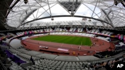 Workers continue preparations ahead of the start of the World Athletics Championships at the London Stadium, in the Queen Elizabeth Olympic Park in London, Aug. 1, 2017. The championships begin on Friday.