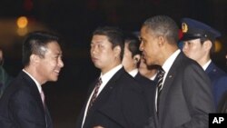 U.S. President Barack Obama is greeted by Japanese Foreign Minister Seiji Maehara as he arrives at Haneda Airport in Tokyo, 12 Nov 2010