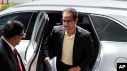 FILE - Riza Aziz, right, stepson of Malaysian former Prime Minister Najib Razak, arrives at Anti-Corruption Agency in Putrajaya, Malaysia, July 3, 2018. 