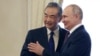 (FILE) Russian President Vladimir Putin, right, and Chinese Foreign Minister Wang Yi shake hands in St. Petersburg, Russia, Wednesday, Sept. 20, 2023.