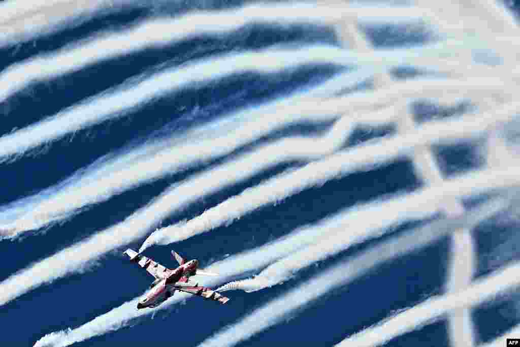 The Indian Air Force Surya Kiran aerobatics team performs during Aero India 2025, a military aviation exhibition at the Yelahanka Air Force Station in Bengaluru.