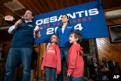 FILE - Republican presidential candidate Florida Gov. Ron DeSantis, left, is joined on stage by his wife Casey DeSantis and children, Madison and Mason, right, during a campaign event at Hudson's Smokehouse BBQ, Saturday, January 20, 2024, in Lexington, S.C.