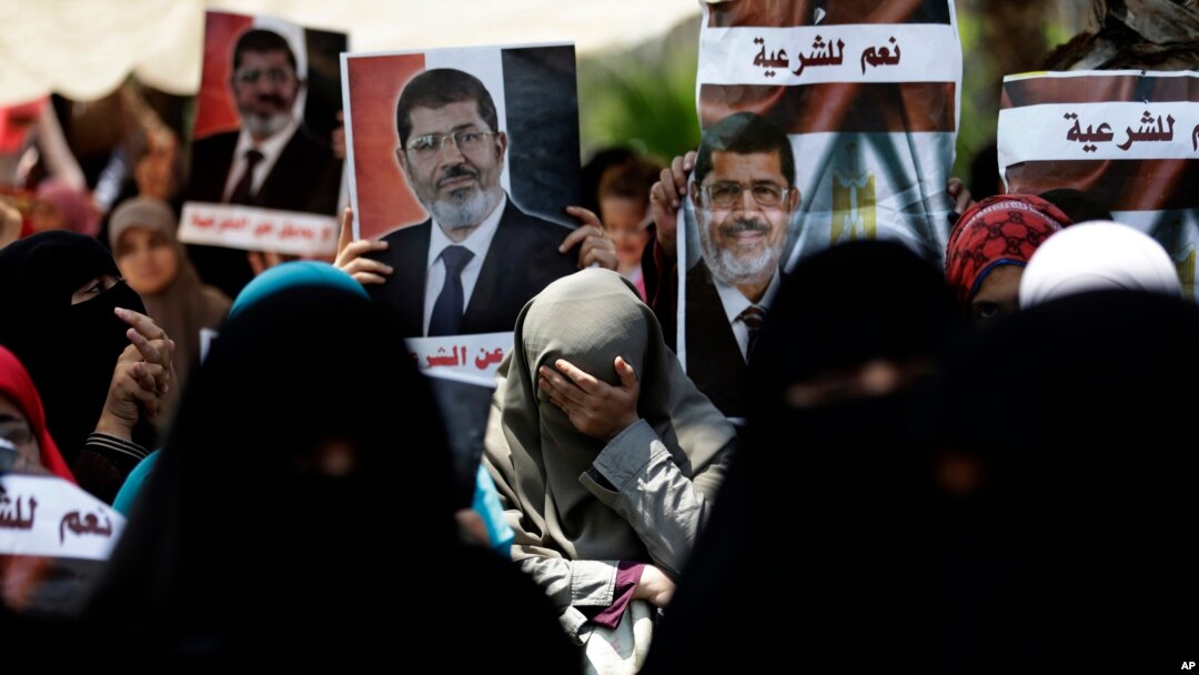 A supporter of ousted Egypt's President Mohammed Morsi cries during a protest near the University of Cairo, Giza, July 5, 2013. 