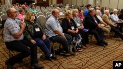 Landowners who object to the Keystone XL pipeline being built through their property sit in the front row as they listen to testimony before the Nebraska Public Service Commission in Lincoln, Nebraska, Aug. 7, 2017.