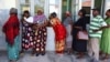 FILE - Local residents queue before casting their votes during the general elections in Inhambane, Mozambique, on Oct. 9, 2024. Two members of the opposition party PODEMOS, which is preparing to challenge the election results, were killed by gunmen on Oct. 18, 2024.