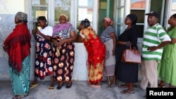 FILE - Local residents queue before casting their votes during the general elections in Inhambane, Mozambique, on Oct. 9, 2024. Two members of the opposition party PODEMOS, which is preparing to challenge the election results, were killed by gunmen on Oct. 18, 2024.