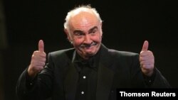 FILE PHOTO: British actor Connery reacts on stage during European film award ceremony in Berlin