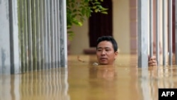 A man wades through flood waters outside his house in Thai Nguyen province in the aftermath of Typhoon Yagi hitting northern Vietnam.&nbsp;Tens of thousands of people were forced to flee their homes as massive floods inundated northern Vietnam and the death toll climbed to 82.&nbsp;