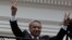 Ecuador's President Lenin Moreno flashes victory hands as he greets supporters from the Government Palace's balcony during the weekly Changing of the Guard, in Quito, Ecuador, Feb. 5, 2018.