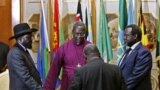 FILE - South Sudan's rebel leader Riek Machar, right, and South Sudan's President Salva Kiir, left, pray before signing a peace agreement in Addis Ababa, May 9, 2014.