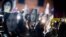 File - People hold pictures of journalist Daphne Caruana Galizia, who was slain in October 2017, as they protest in Valletta, Malta, Nov. 29, 2019.