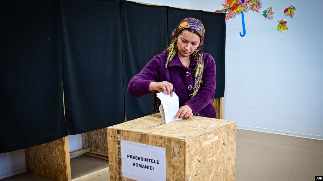 (ARCHIVO) Una mujer deposita su voto para las elecciones presidenciales en un colegio electoral en el pueblo de Galbinasi, Rumania, el 24 de noviembre de 2024. AFP
