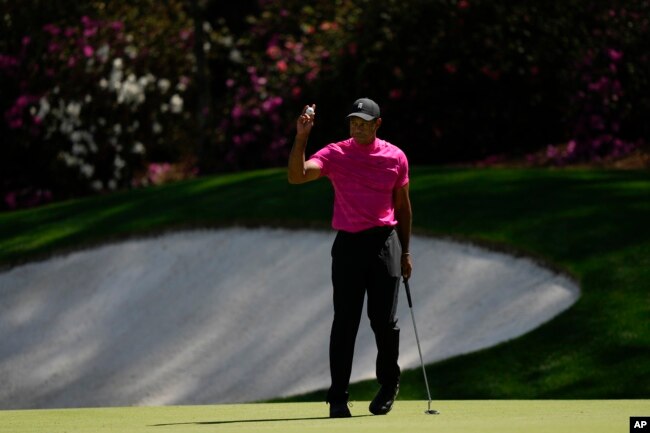 Tiger Woods holds up his ball after a birdie on the 13th hole during the first round at The Masters. (AP Photo/Matt Slocum)