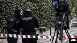 Greek police set up a security perimeter near the house of Giorgos Karaivaz, a veteran crime journalist, after he was shot dead in Athens, April 9, 2021.