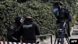 Greek police set up a security perimeter near the house of Giorgos Karaivaz, a veteran crime journalist, after he was shot dead in Athens, April 9, 2021.