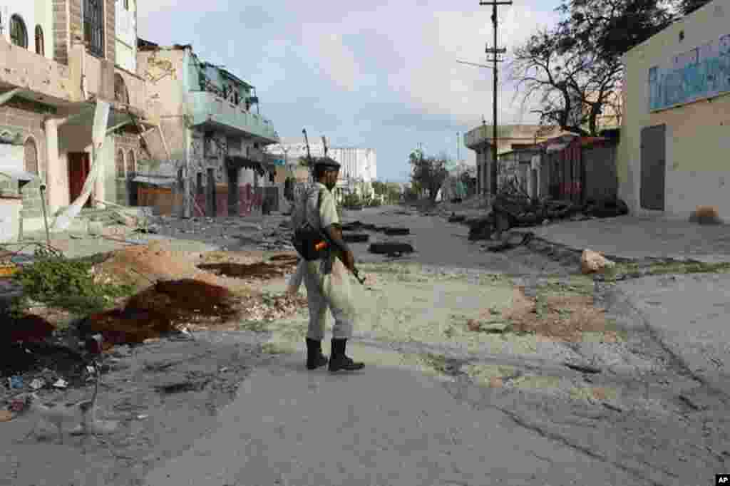 A solitary soldier surveys the damage (VOA - P. Heinlein)