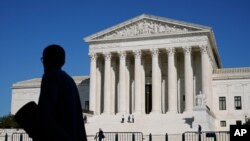 FILE - Officials stand on the Supreme Court steps on Capitol Hill in Washington, Sept. 22, 2020,