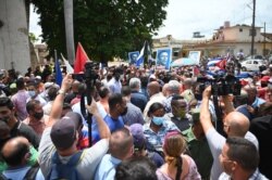 Cuban President Miguel Diaz-Canel (C) is seen during a protest held by citizens demanding improvements in the country, in San Antonio de los Banos, Cuba, July 11, 2021.