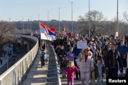 Demonstrators march to protest graft they blame for 15 deaths in a building collapse, in Novi Sad, Serbia, Feb. 1, 2025.