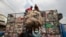 FILE - Workers load collected plastic bottles on to a truck at a junk shop in Manila, March 10, 2015. The Philippines placed third among the list of countries with the most ocean plastic pollution per year. 