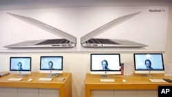 Portraits of the late Steve Jobs illuminate Computer monitors in an Apple retail store in Taiwan, Oct. 6, 2011. (AP)