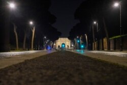 An empty street is seen after 10 p.m. on the first day of the national night time curfew due to new coronavirus measures, in Rome, Italy, Nov. 6, 2020.