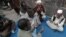 Neighbors pray outside the residence of 62-year-old heart patient Chaudhry Mohammad Gulab after he was buried in Lahore on January 27, 2012. Gulab's health started to deteriorate after he was prescribed a new medication, his younger brother said. 