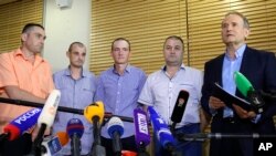 (L-R) Ukraine's Yakov Veremeychik, Maxim Goryainov, Dmitry Veliki, Eduard Mikheev, who were held in separatist captivity, talk to media at the National airport, Minsk, Belarus, June 28, 2019.